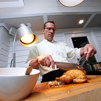 Chef slices a Cornish Game Hen on the Fairway Buffet
